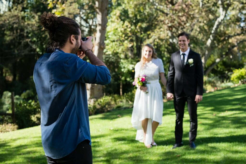 Photographer taking photo of newly married couple