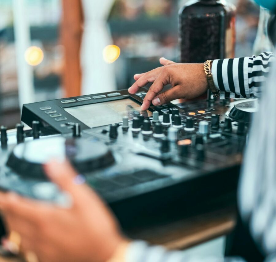 Close up dj hand mixing music at cocktail bar - Party nightlife concept